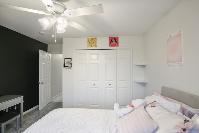 bedroom featuring dark colored carpet, ceiling fan, and a closet