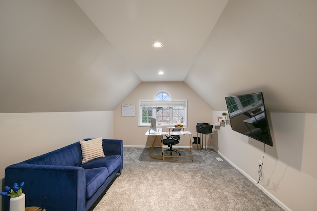 carpeted office with vaulted ceiling