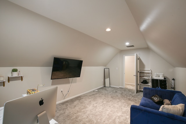 carpeted living room featuring lofted ceiling