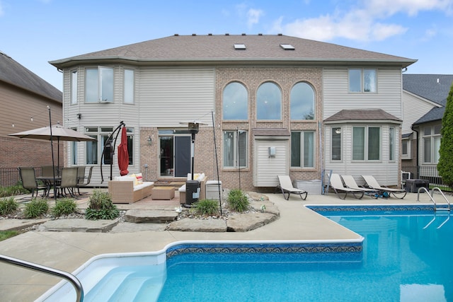 back of property featuring outdoor lounge area and a patio