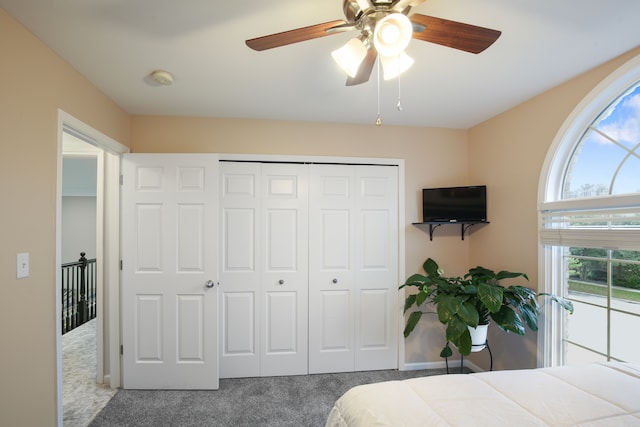 bedroom with ceiling fan, a closet, and carpet