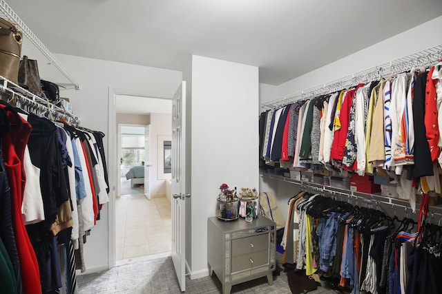 spacious closet featuring tile patterned flooring