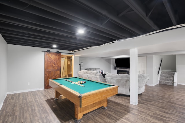 recreation room featuring a barn door, wood-type flooring, and pool table