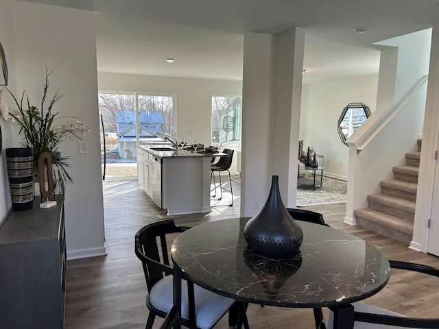 dining space with sink and hardwood / wood-style floors