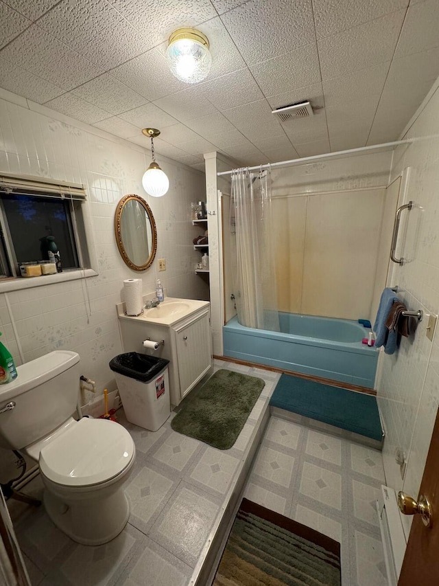 full bathroom with toilet, vanity, and shower / tub combo with curtain