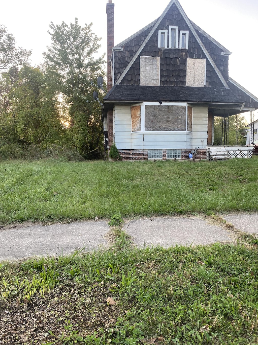 12835 Mark Twain St, Detroit, MI 48227 - view of side of home featuring a chimney and a lawn