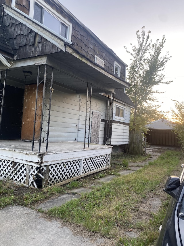 property exterior at dusk with covered porch