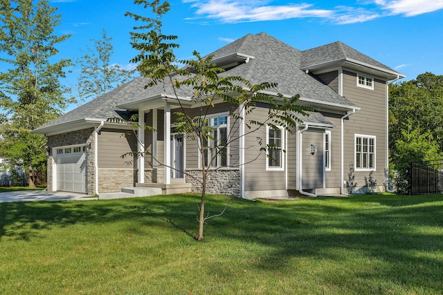 view of front of house with a garage and a front lawn