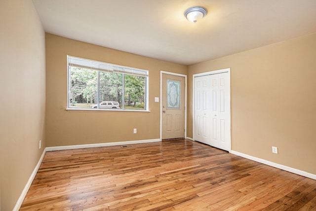 unfurnished bedroom with light hardwood / wood-style floors and a closet