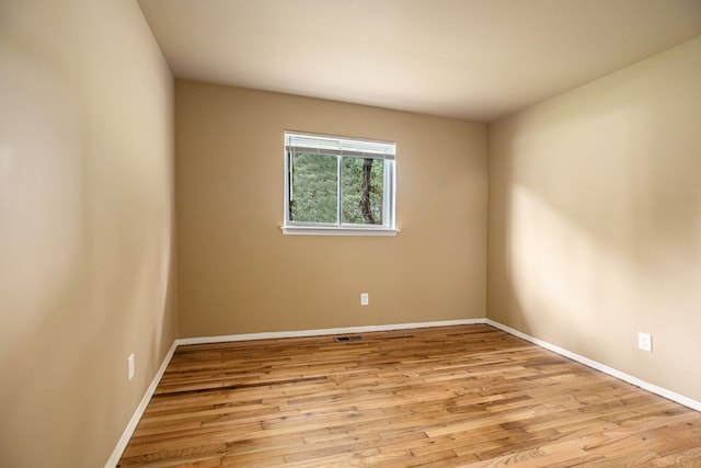 unfurnished room with light wood-type flooring