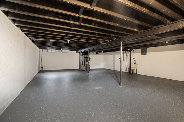 basement with heating unit, sink, and electric panel