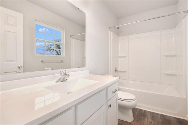 full bathroom with toilet, wood-type flooring, vanity, and bathtub / shower combination