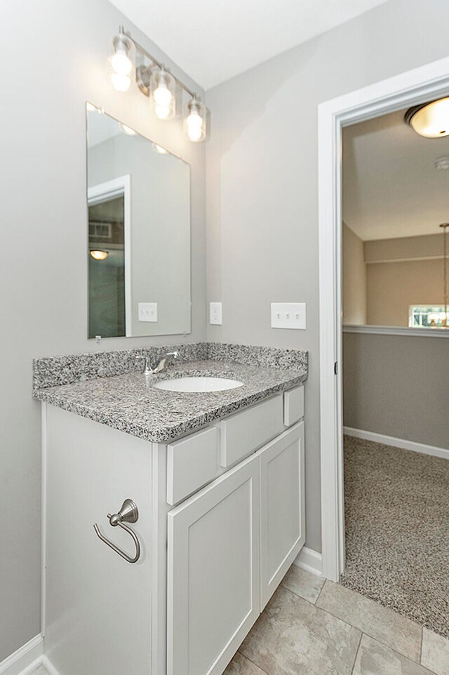 bathroom featuring vanity and baseboards