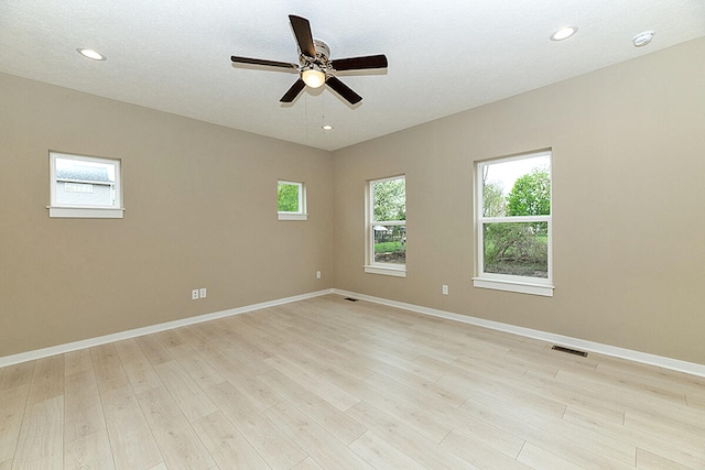 unfurnished room featuring visible vents, recessed lighting, light wood-type flooring, and baseboards