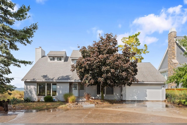300 Marquette Dr, New Buffalo, MI 49117 - view of front of property featuring an attached garage, driveway, a chimney, and a shingled roof