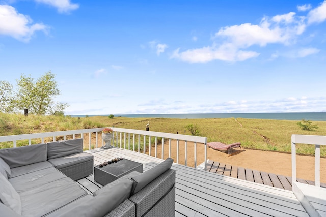 wooden terrace with outdoor lounge area and a water view