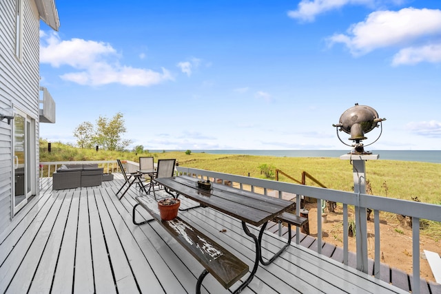deck with a water view and outdoor lounge area