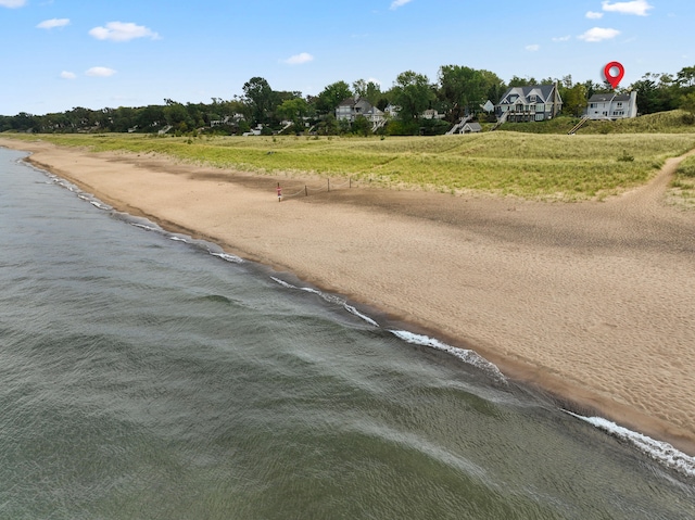 view of street featuring a water view and a beach view