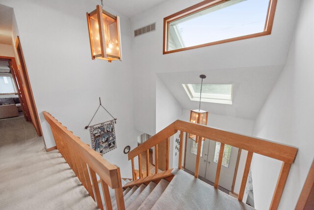 300 Marquette Dr, New Buffalo, MI 49117 - staircase with a skylight, carpet floors, and high vaulted ceiling