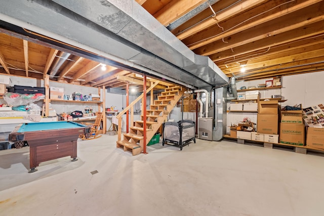 unfinished basement with stairs, pool table, and heating unit