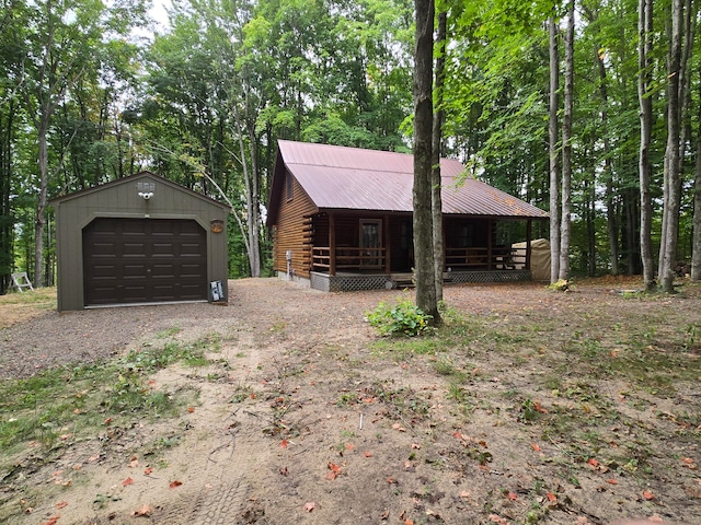 log cabin featuring an outdoor structure and a garage