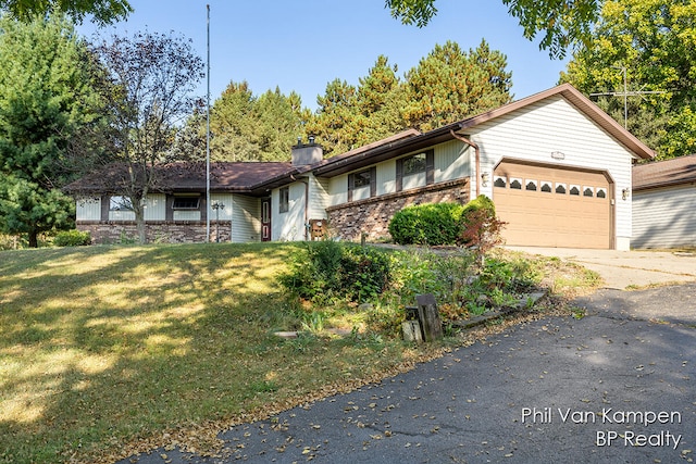 view of front of property with a garage and a front lawn