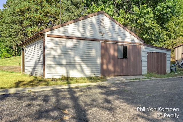 view of side of property with a garage and an outdoor structure