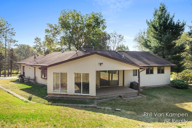 back of property featuring central AC, a yard, and a patio