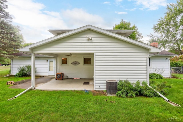 back of property featuring a lawn, central AC unit, and a patio