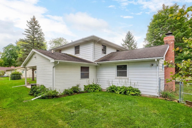 back of house with a yard and a carport