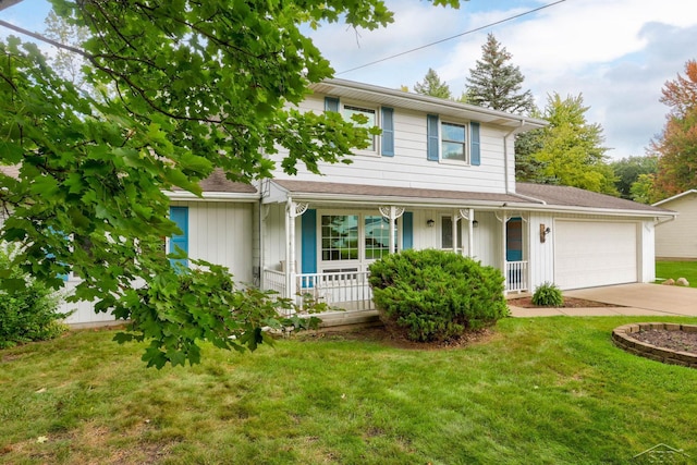 view of front of house featuring a front yard, a porch, and a garage