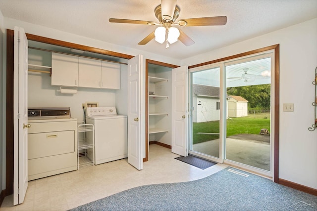 laundry area featuring washer and clothes dryer, ceiling fan, cabinets, and a textured ceiling