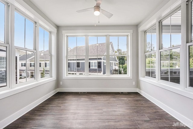 unfurnished sunroom featuring ceiling fan