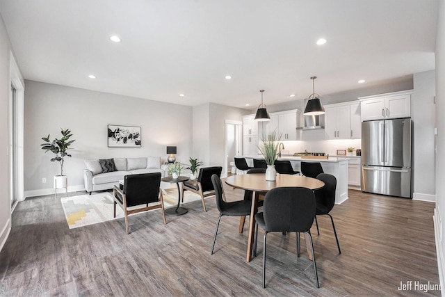 dining space with sink and dark wood-type flooring