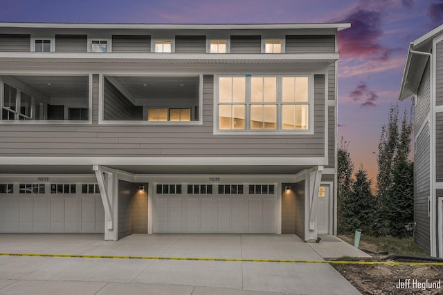 property exterior at dusk featuring a garage