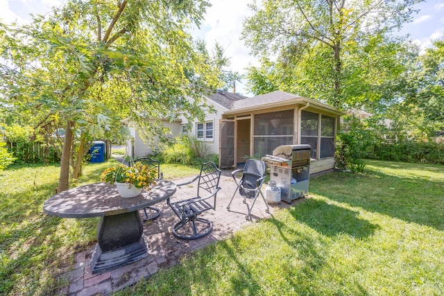 view of yard with a sunroom, a fire pit, and a patio