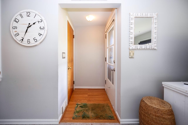 hall with light hardwood / wood-style flooring