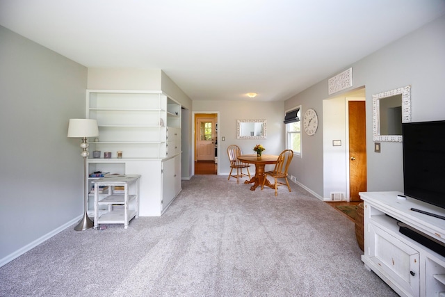 sitting room featuring light colored carpet