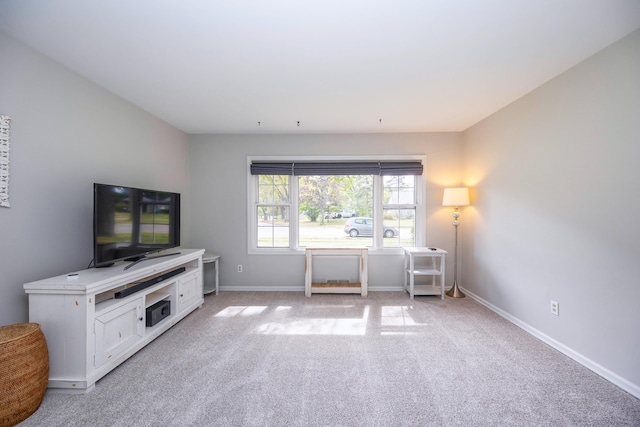 unfurnished living room featuring light colored carpet