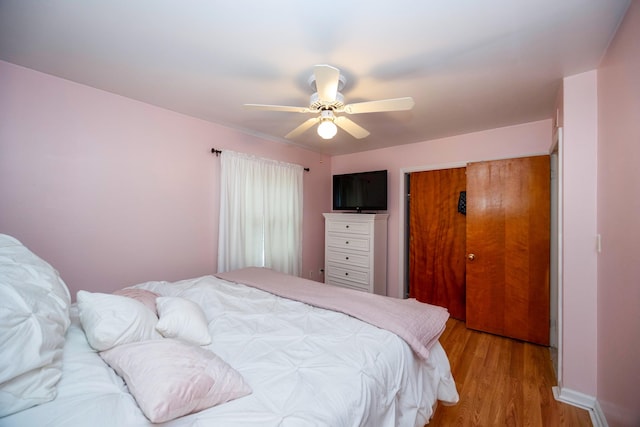 bedroom featuring ceiling fan, a closet, and light hardwood / wood-style flooring