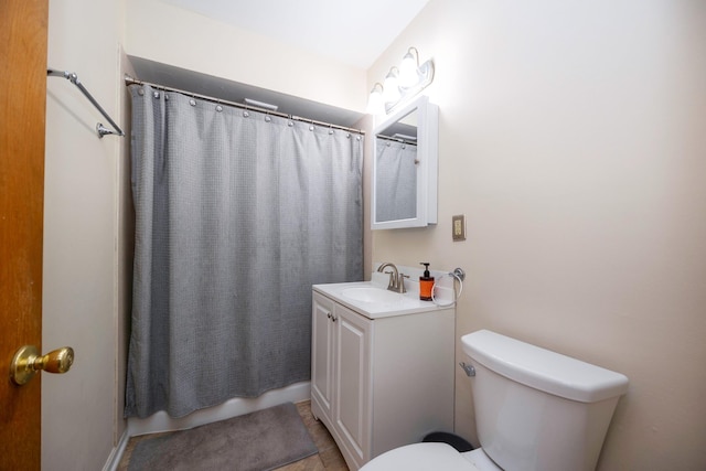 bathroom with a shower with shower curtain, vanity, toilet, and tile patterned flooring