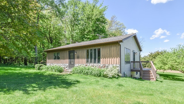 11768 Riker Rd, Litchfield, MI 49252 - view of front of house featuring stone siding, a front lawn, board and batten siding, and a shingled roof
