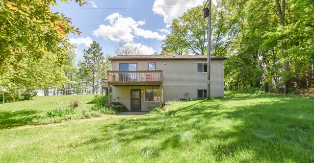 11768 Riker Rd, Litchfield, MI 49252 - back of house with a wooden deck and a lawn