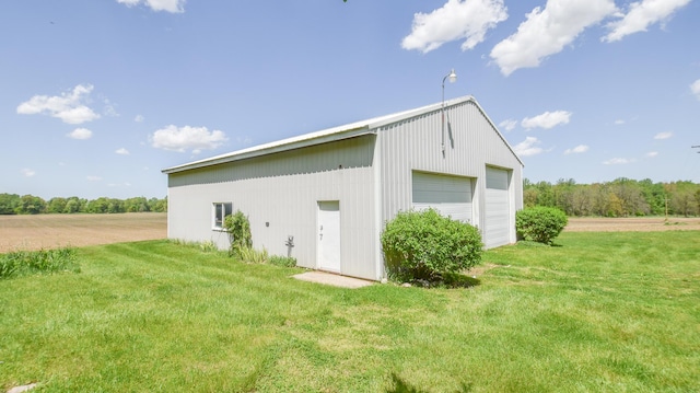 11768 Riker Rd, Litchfield, MI 49252 - view of side of property featuring a garage, an outdoor structure, and a yard