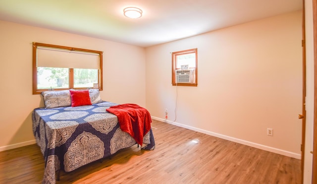 11768 Riker Rd, Litchfield, MI 49252 - bedroom with light wood finished floors, baseboards, and cooling unit