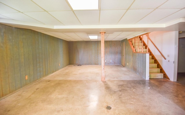 11768 Riker Rd, Litchfield, MI 49252 - finished basement featuring a paneled ceiling, stairs, and wooden walls