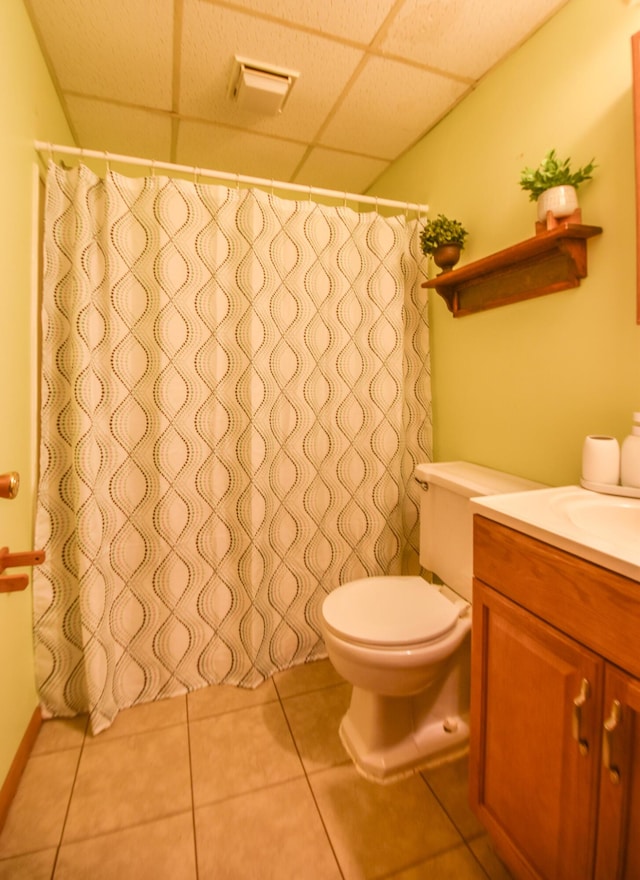 11768 Riker Rd, Litchfield, MI 49252 - full bathroom with a drop ceiling, vanity, toilet, tile patterned flooring, and a shower with shower curtain