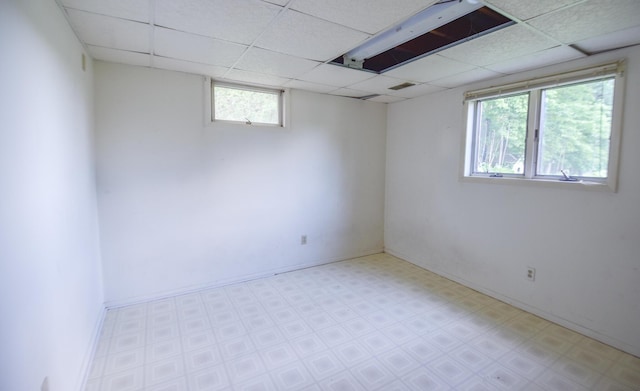 11768 Riker Rd, Litchfield, MI 49252 - basement featuring a paneled ceiling, tile patterned floors, and baseboards