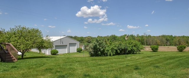 11768 Riker Rd, Litchfield, MI 49252 - view of grassy yard featuring a garage, an outdoor structure, and stairway