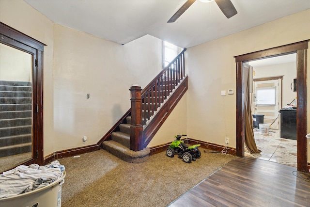 stairs with hardwood / wood-style flooring, plenty of natural light, and ceiling fan